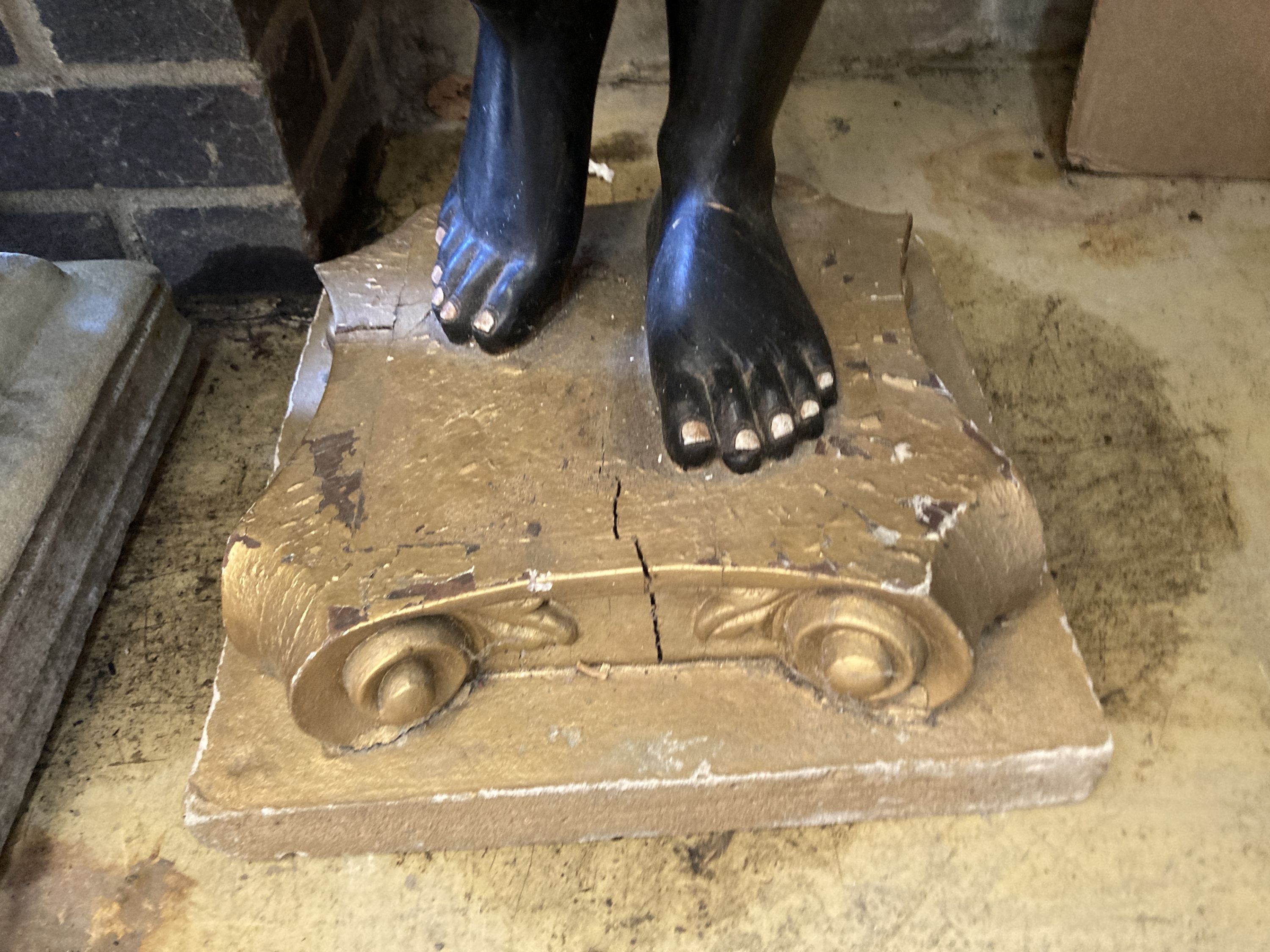 A carved, painted and gilded wood figural dumb waiter,